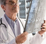 A doctor using an x-ray to analyze a problem.